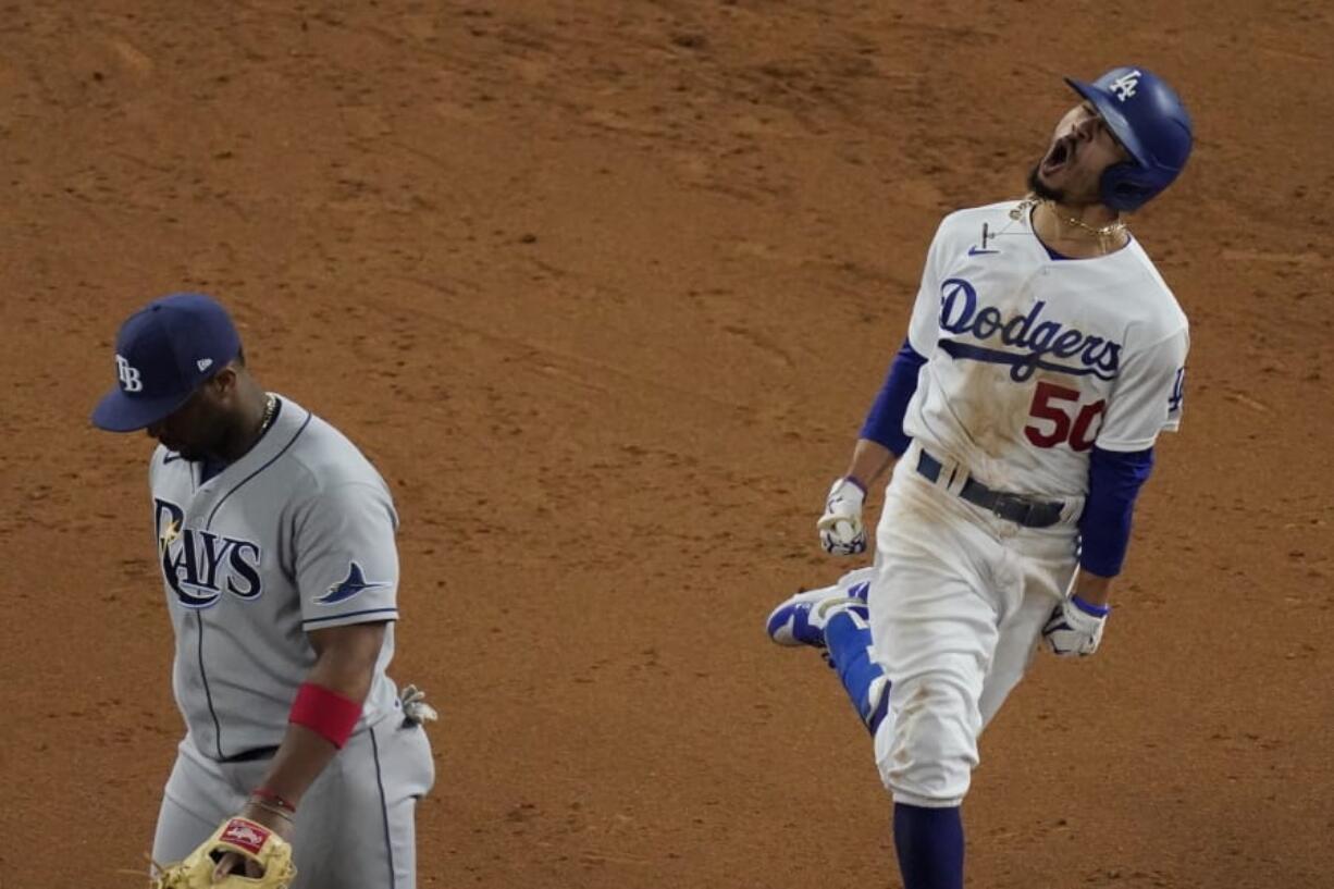 Los Angeles Dodgers&#039; Mookie Betts celebrates after a home run against the Tampa Bay Rays during the eighth inning in Game 6 of the baseball World Series Tuesday, Oct. 27, 2020, in Arlington, Texas.