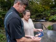 John Bruns and Heather Wendling look at a picture of their daughter, London. London died by suicide in September and the couple now spends their time raising awareness of teen suicide.