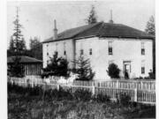 This 1892 photo may be of the first building for the Washington School for Defective Youth and matches the description as part farmhouse in reports. By 1892, the Legislature funded a second, more suitable brick building. Despite its odious name, concerns for the disabled reach back into Washington&#039;s territorial days. Several early attempts failed. Then in 1886, the territorial legislature approved funding for a state school to educate the disabled and located it in Vancouver. The photo places the school at Fourth Plain (then a general locality, not a street) and Burnt Bridge Creek.