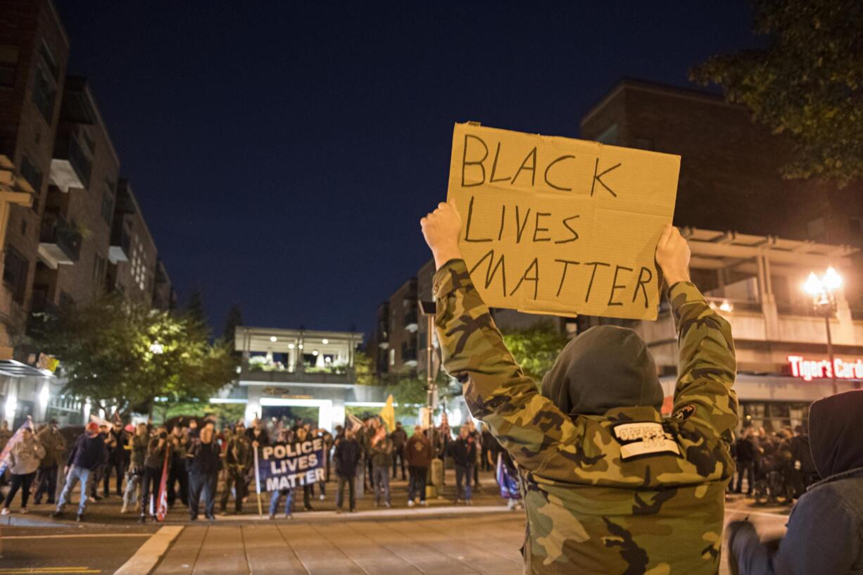 Black Lives Matter protesters face off against Blue Lives Matter and Patriot Prayer supporters in downtown Vancouver near Esther Short Park on Saturday night, Oct. 31, 2020.