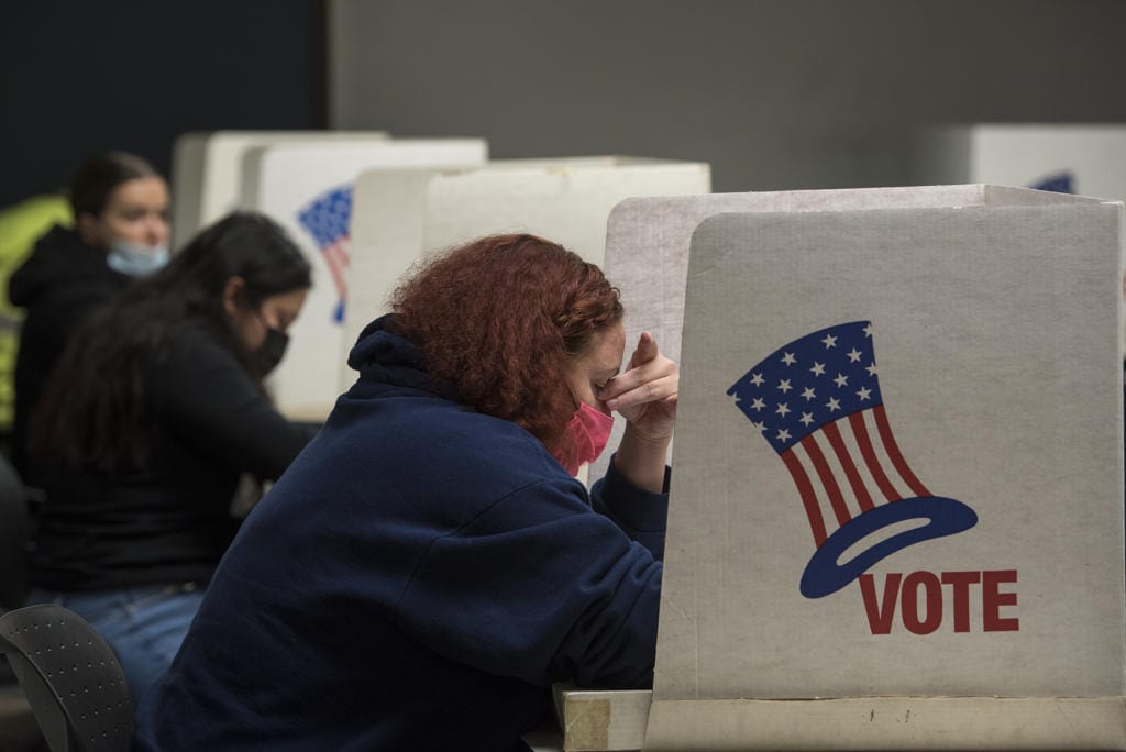 Vancouver resident Melissa Taylor keeps her concentration as she joins fellow residents while voting at the Clark County Elections Office on Tuesday afternoon, Nov. 3, 2020.