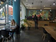 Customer Emily Carroll of Vancouver works on her laptop while stopping by Kafiex Roasters Coffee Lab in downtown Vancouver on Monday afternoon.