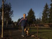 Karen Bean of Vancouver keeps in step with her dog, DeeDee at Hearthwood Park. Bean lost 100 pounds during the pandemic. She has plans to move to Oklahoma soon to live with her granddaughters.