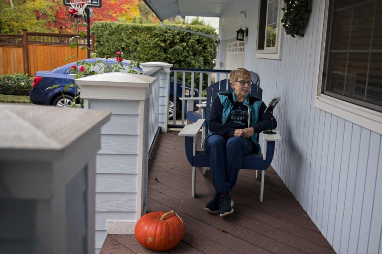 Dawn Iveane-Curell, a Meals on Wheels People Friendly Chat volunteer, talks with seniors on the phone in her bedroom office or while on walks as part of the program.