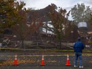 Gary Dunne of Vancouver pauses to take photos during the demolition of the former downtown location of New Heights Church on Friday morning. Dunne was joined by his wife, Marlene, who he married at the church in 1959. The couple raised three daughters there. "It just felt like home," Marlene Dunne said.