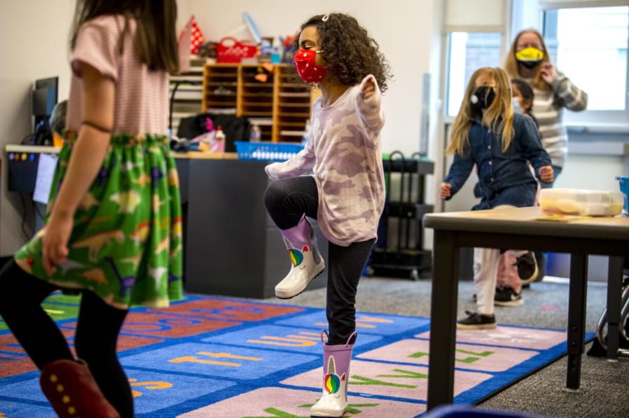 Jade Westbrooks, 5, stomps her feet as part of a counting exercise in Molly Davenport&#039;s kindergarten class Tuesday morning at Marshall Elementary in Vancouver. Kindergartners recently began in-person learning in Vancouver Public Schools.