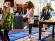 Jade Westbrooks, 5, stomps her feet as part of a counting exercise in Molly Davenport&#039;s kindergarten class Tuesday morning at Marshall Elementary in Vancouver. Kindergartners recently began in-person learning in Vancouver Public Schools.