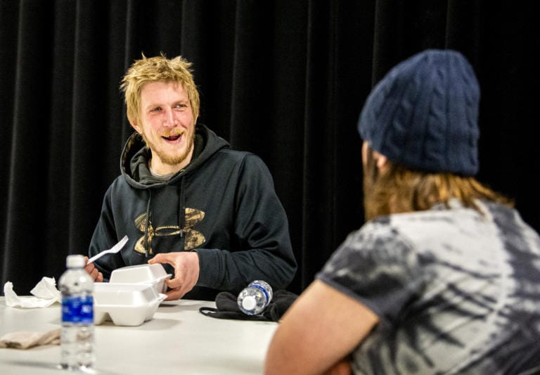 Vancouver resident Jeff Nagle, left, finishes up his meal and readies to start on his pumpkin pie while talking with Jeremy Lincoln on Saturday, November 21, 2020 at Living Hope Church. The Church expected to serve 2,000 people on Saturday.