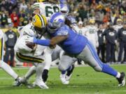 Green Bay quarterback Aaron Rodgers (12) is sacked by Detroit defensive tackle Damon ‘Snacks’ Harrison in a 2019 game. Harrison is set to make his debut with the Seattle Seahawks on Sunday against the Los Angeles Rams.