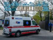 An ambulance arrives at a parking lot at the Bronx Zoo on April 23, in New York City. Seven more big cats have reportedly tested positive for the coronavirus after a tiger tested positive earlier in the month.