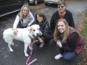 Pet finder Cathy Herman-Harsch (top right) and volunteers Tina (far left) and Jackie Burton (far right), pose with grateful client Karen Jackson (center) and her dog Trixie at the Jackon family&#039;s West Chester, Pa., home. (Steven M.