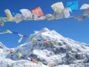 Prayer flags flutter in the breeze at Mount Everest.