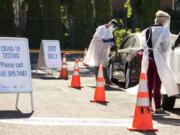 Faculty members from Washington State University Health Sciences Spokane administer COVID-19 tests to students at a mobile testing site in September during the coronavirus pandemic on campus in Pullman.