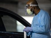 People waited in long lines for drive-through COVID-19 tests administered by OHSU at the Oregon Convention Center on Thurs., Nov. 12, 2020.