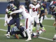 Seattle Seahawks running back DeeJay Dallas, left, scores a touchdown against the San Francisco 49ers during the second half of an NFL football game, Sunday, Nov. 1, 2020, in Seattle. The Seahawks won 37-27.