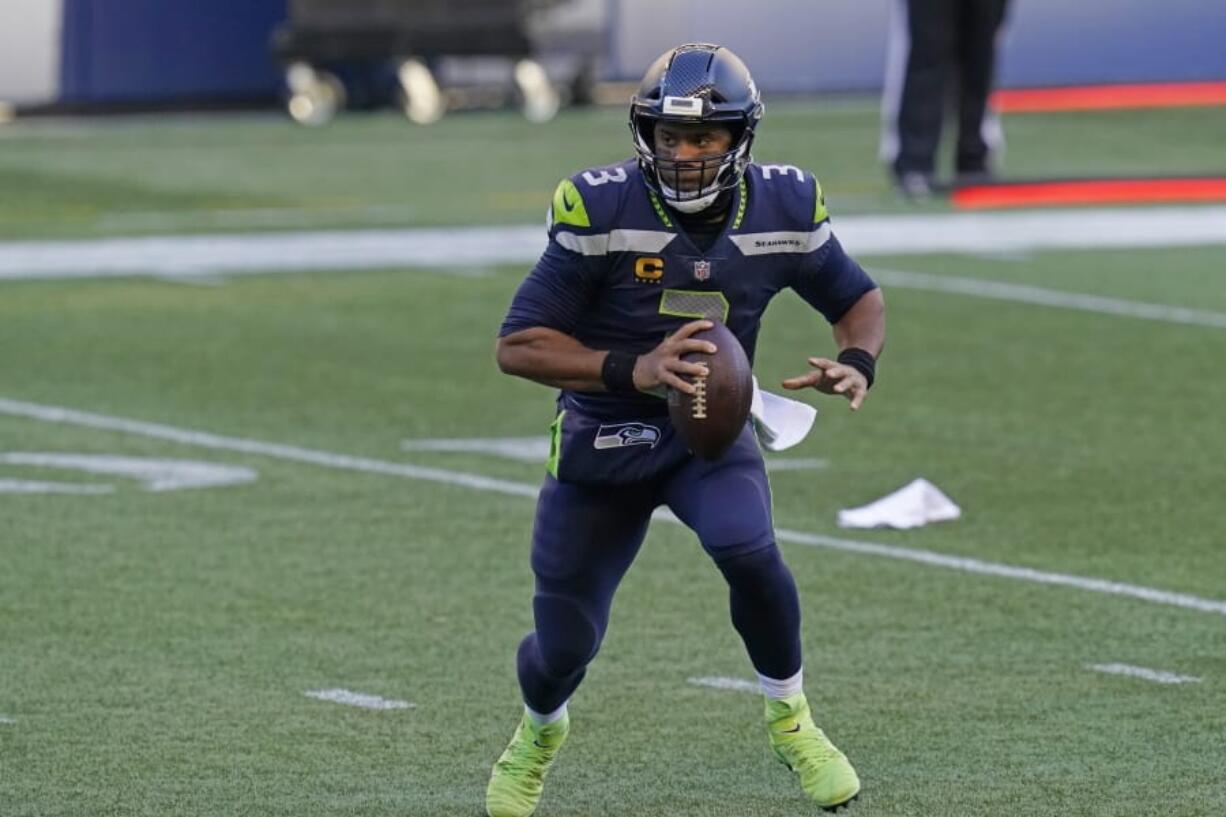 Seattle Seahawks quarterback Russell Wilson scrambles to pass against the San Francisco 49ers during the second half of an NFL football game, Sunday, Nov. 1, 2020, in Seattle.