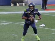 Seattle Seahawks quarterback Russell Wilson scrambles to pass against the San Francisco 49ers during the second half of an NFL football game, Sunday, Nov. 1, 2020, in Seattle.