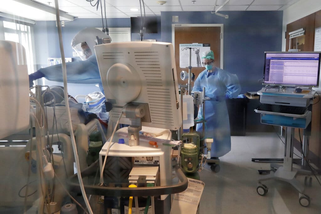 FILE - In this May 8, 2020, file photo, medical personal work on a patient in the COVID-19 Intensive Care Unit at Harborview Medical Center, which is part of Seattle-area health care system UW Medicine in Seattle.