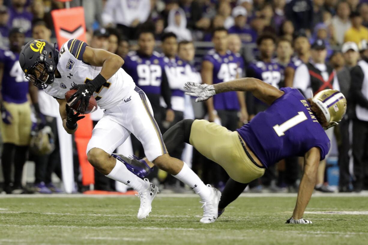 California cornerback Camryn Bynum, left, intercepts a pass intended for Washington tight end Hunter Bryant (1) during the game in Seattle in 2019. Bynum changed his mind and returned to the Cal program after previously having announced he would enter the 2021 NFL draft. (AP Photo/Ted S.