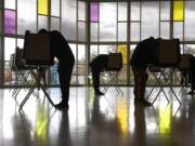 Voters mark their ballots at First Presbyterian Church on Election Day, Tuesday, Nov. 3, 2020, in Stamford, Conn.