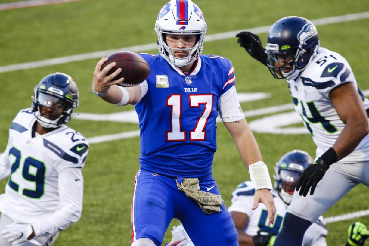 Buffalo Bills quarterback Josh Allen (17) rushes past Seattle Seahawks' Bruce Irvin (51) and Jayson Stanley (29) for a touchdown during the second half of an NFL football game Sunday, Nov. 8, 2020, in Orchard Park, N.Y. (AP Photo/Jeffrey T.