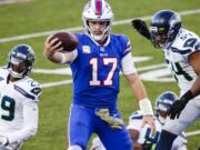 Buffalo Bills quarterback Josh Allen (17) rushes past Seattle Seahawks' Bruce Irvin (51) and Jayson Stanley (29) for a touchdown during the second half of an NFL football game Sunday, Nov. 8, 2020, in Orchard Park, N.Y. (AP Photo/Jeffrey T.