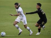 Portland Timbers midfielder Diego Valeri, left, handles the ball while pressured by Los Angeles FC midfielder Eduard Atuesta during the first half of an MLS soccer match in Los Angeles, Sunday, Nov. 8, 2020.