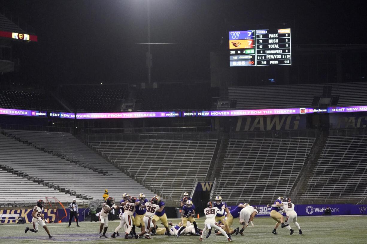 Washington running back Sean McGrew (5) rushes against Oregon State in a Husky Stadium void of fans during the coronavirus pandemic, during the first half of an NCAA college football game Saturday, Nov. 14, 2020, in Seattle. (AP Photo/Ted S.