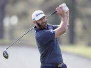 Dustin Johnson tees off on the third hole during the final round of the Masters golf tournament Sunday, Nov. 15, 2020, in Augusta, Ga.