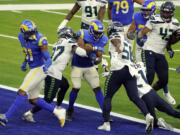 Los Angeles Rams running back Malcolm Brown, center, scores a rushing touchdown against the Seattle Seahawks during the second half of an NFL football game Sunday, Nov. 15, 2020, in Inglewood, Calif.