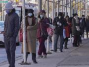 FILE - People wait on a line stretching around a block for a clinic offering COVID-19 testing, Wednesday, Nov. 18, 2020, in the Park Slope area of the Brooklyn borough of New York. The lines for free COVID-19 tests stretch for blocks and hours in cities feeling the dual strain of the coronavirus surge and holiday plans. But $150 or more can buy a spot at the front of the queue. Some are turning to of one of an increasing number of pop-up clinics that promise visitors instant results — at a cost.