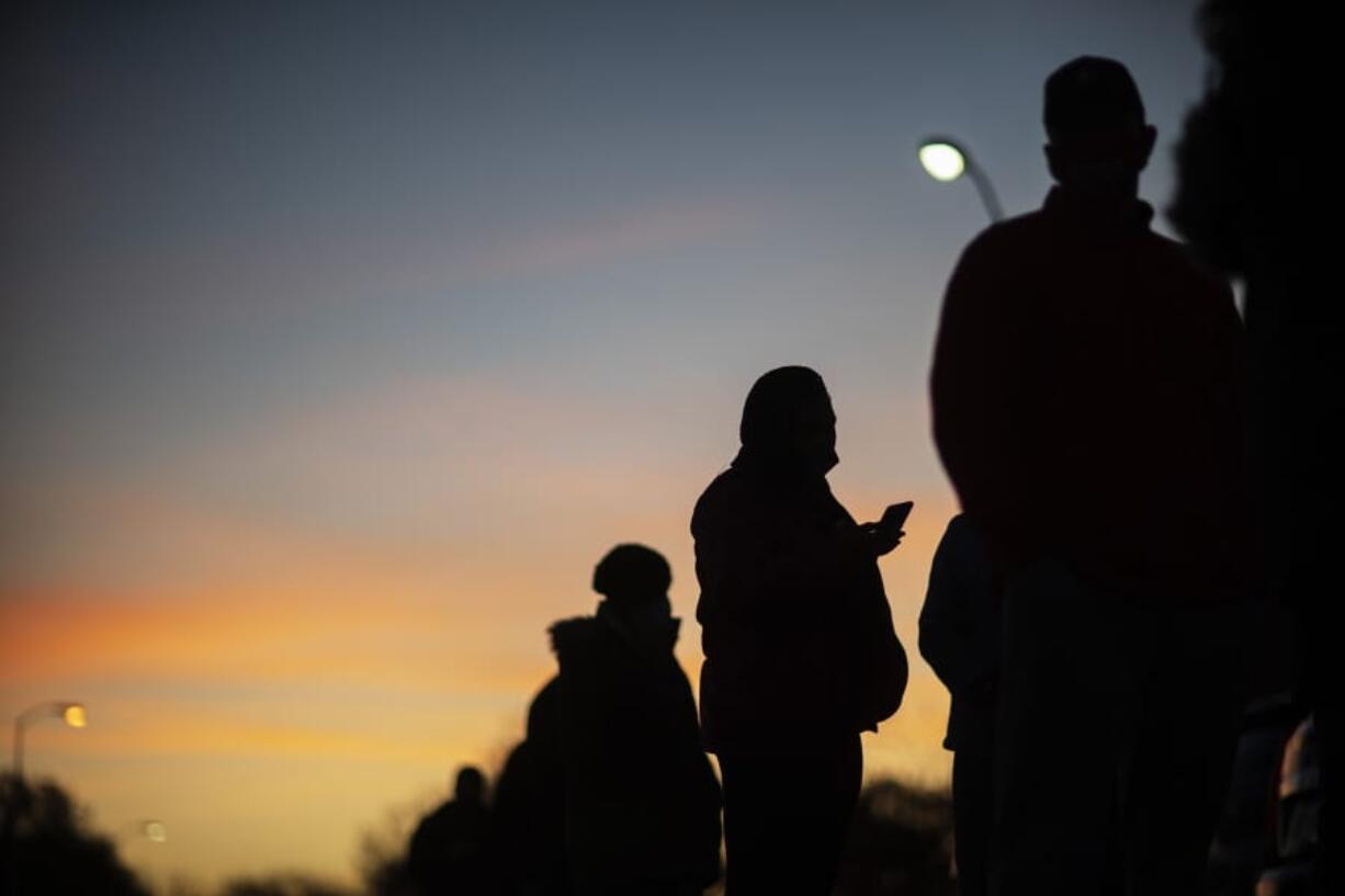 Voters line up before polls open on Election Day at a precinct in Warren, Mich., Tuesday, Nov. 3, 2020.