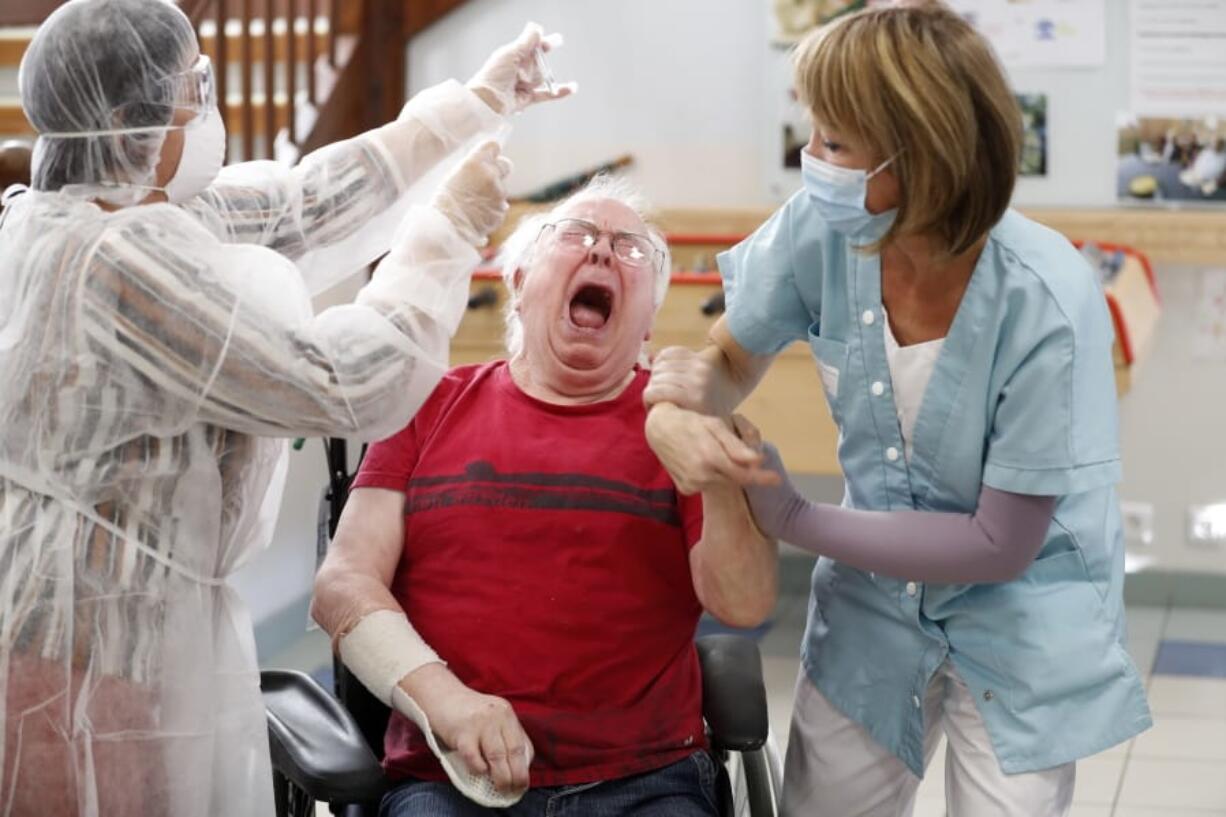 A resident of a nursing home is being tested with a PCR test in Ammerschwihr, eastern France, Monday, Nov.9, 2020. The antigen tests can give results in 15-30 minutes, and if they turn out positive, the patient is sent for a PCR test to confirm the result.