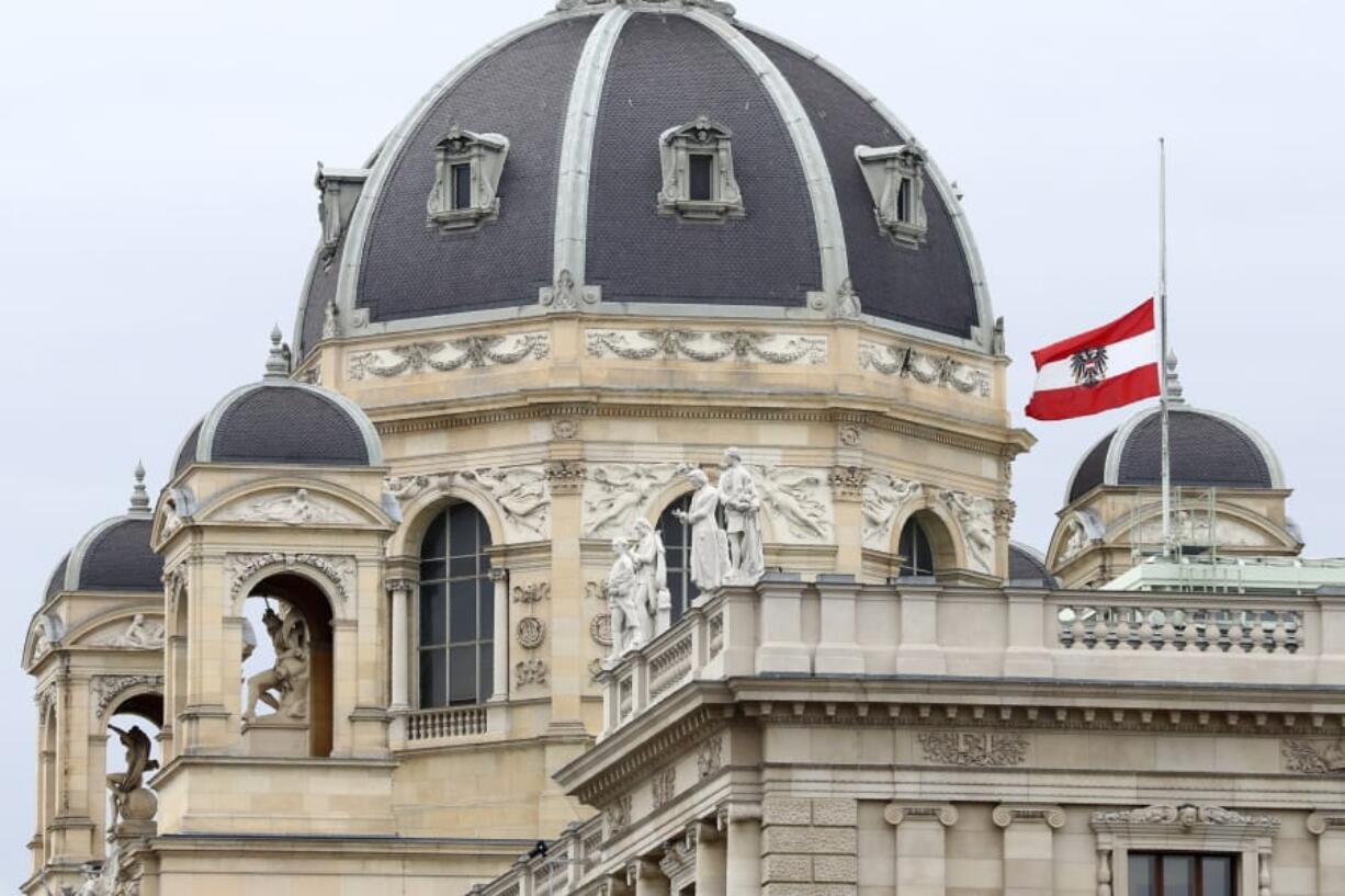 The Austrian national flag waves of half-mast on a building downtown in Vienna, Austria, Wednesday, Nov. 4, 2020. Several shots were fired shortly after 8 p.m. local time on Monday, Nov. 2, in a lively street in the city center of Vienna.