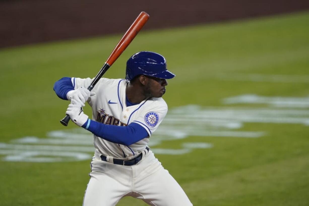 FILE - In this Aug. 23, 2020, file photo, Seattle Mariners&#039; Kyle Lewis begins his swing on a solo home run against the Texas Rangers during the first inning of a baseball game in Seattle. The BBWAA finalists for AL Rookie of the Year are Houston Astros right-hander Cristian Javier and Lewis of the Mariners and Luis Robert of the White Sox. Philadelphia Phillies infielder Alec Bohm, San Diego Padres infielder Jake Cronenworth and Milwaukee Brewers reliever Devin Williams are the top finishers for the NL rookie award. (AP Photo/Ted S.