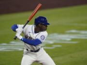 FILE - In this Aug. 23, 2020, file photo, Seattle Mariners&#039; Kyle Lewis begins his swing on a solo home run against the Texas Rangers during the first inning of a baseball game in Seattle. The BBWAA finalists for AL Rookie of the Year are Houston Astros right-hander Cristian Javier and Lewis of the Mariners and Luis Robert of the White Sox. Philadelphia Phillies infielder Alec Bohm, San Diego Padres infielder Jake Cronenworth and Milwaukee Brewers reliever Devin Williams are the top finishers for the NL rookie award. (AP Photo/Ted S.