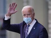 President-elect Joe Biden wavs as he leaves The Queen theater, Tuesday, Nov. 10, 2020, in Wilmington, Del.