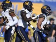 California cornerback Camryn Bynum, right, celebrates after intercepting a pass during the first half of an NCAA college football game against UCLA in Los Angeles, Sunday, Nov. 15, 2020.