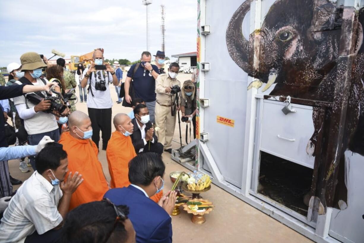 The container holding Kaavan the elephant is blessed by monks during its arrival from Pakistan at the Siem Reap International Airport, Cambodia, Monday, Nov. 30, 2020. Kaavan, dubbed the &quot;world&#039;s loneliest elephant&quot; after languishing alone for years in a Pakistani zoo, has arrived in Cambodia where a sanctuary with the much-needed company of other elephants awaits him.