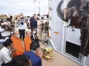 The container holding Kaavan the elephant is blessed by monks during its arrival from Pakistan at the Siem Reap International Airport, Cambodia, Monday, Nov. 30, 2020. Kaavan, dubbed the &quot;world&#039;s loneliest elephant&quot; after languishing alone for years in a Pakistani zoo, has arrived in Cambodia where a sanctuary with the much-needed company of other elephants awaits him.