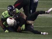 Seattle Seahawks defensive end Carlos Dunlap II (43) sacks Arizona Cardinals quarterback Kyler Murray on fourth down late in the fourth quarter Thursday, Nov. 19, 2020, in Seattle. The sack sealed the Seahawks&#039; 28-21 win.