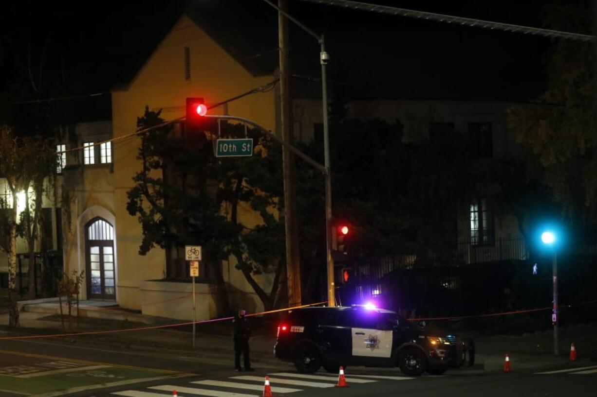 San Jose Police investigate a possible stabbing at Grace Baptist Church at the corner of South 10th and East San Fernando Streets in downtown San Jose, Calif., Sunday, Nov. 22, 2020. Two people died and multiple others were injured in a stabbing Sunday night at a church in California where homeless people had been brought to shelter from the cold weather, police said. (Nhat V.