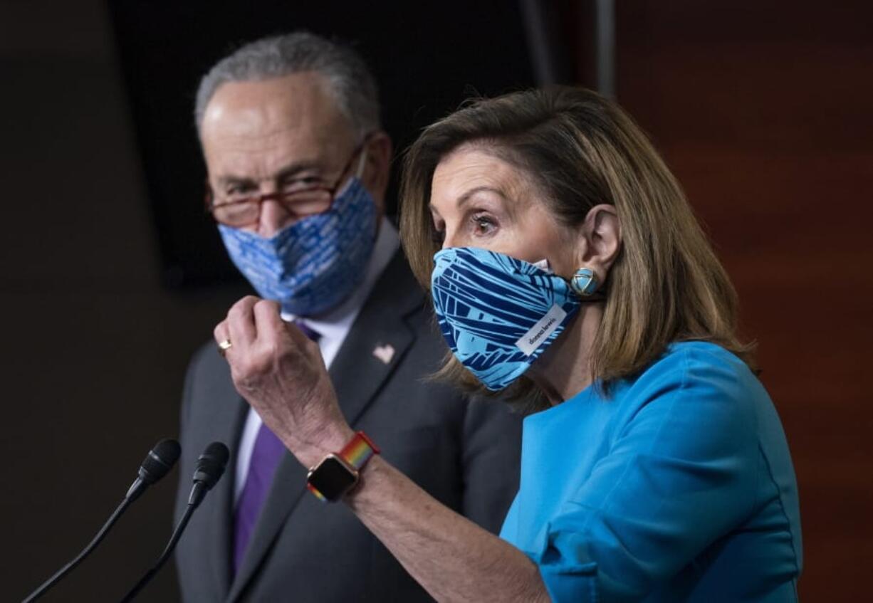 Speaker of the House Nancy Pelosi, D-Calif., and Senate Minority Leader Chuck Schumer, D-N.Y., left, meet with reporters on Capitol Hill in Washington, Thursday, Nov. 12, 2020. (AP Photo/J.