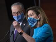 Speaker of the House Nancy Pelosi, D-Calif., and Senate Minority Leader Chuck Schumer, D-N.Y., left, meet with reporters on Capitol Hill in Washington, Thursday, Nov. 12, 2020. (AP Photo/J.