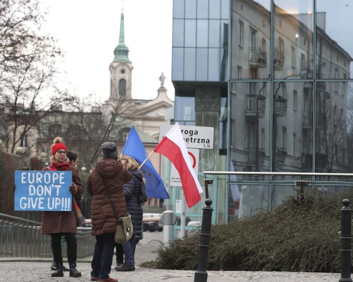 FILE - In this Jan. 28, 2020, file photo, demonstrators protest against Poland&#039;s government&#039;s efforts to control the court system in front of the Supreme Court in Warsaw, Poland. The European Union still hasn&#039;t completely sorted out its messy post-divorce relationship with Britain -- but it has already been plunged into another major crisis. This time the 27-member union is being tested as Poland and Hungary block passage of its budget for the next seven years and an ambitious package aimed at rescuing economies ravaged by the coronavirus pandemic.