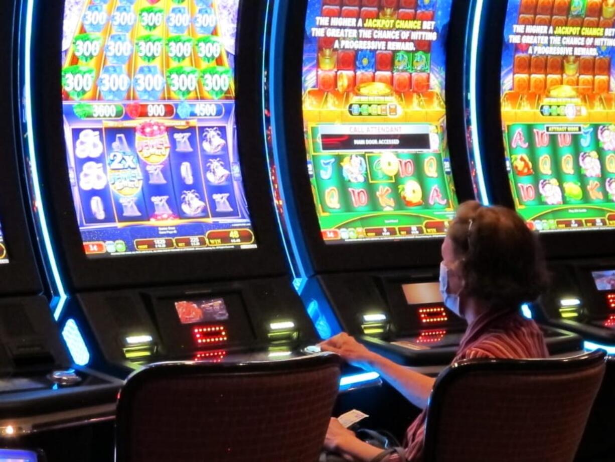 A woman plays a slot machine at the Golden Nugget casino in Atlantic City, N.J. on July 2, 2020. The U.S. gambling industry was a big winner at the polls on Nov. 3, 2020, with three states authorizing sports betting and three others either authorizing or expanding casino gambling.