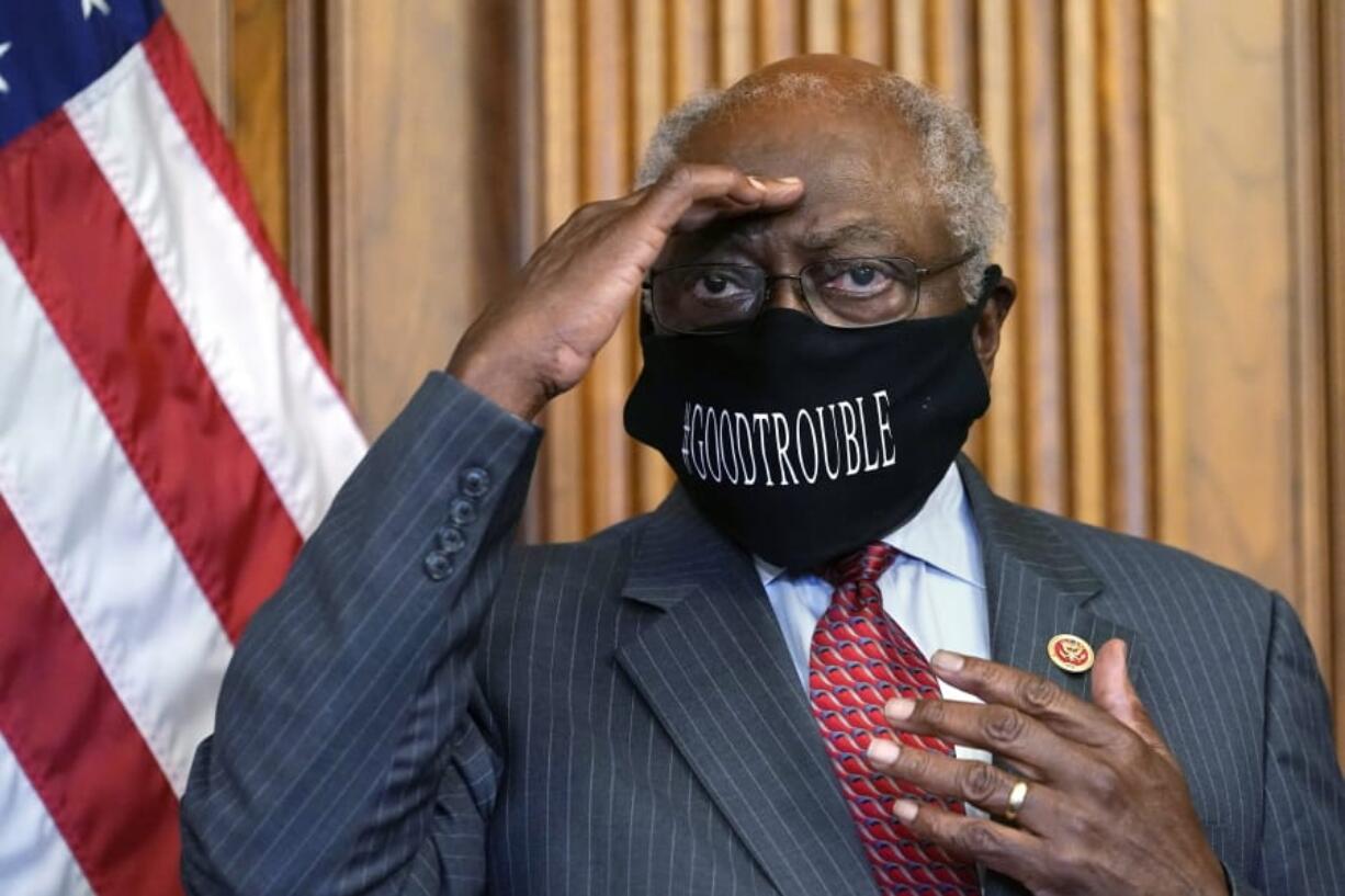 FILE - In this Sept. 17, 2020, file photo, House Majority Whip James Clyburn of South Carolina shields his eyes from a television light to look at a reporter asking a question during a news conference with House Speaker Nancy Pelosi on Capitol Hill. Clyburn and other Democrats blamed rhetoric about defunding local police departments for the party&#039;s surprise loss of seats in the House.