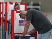 A voter marks his ballot at the Kentucky Exposition Center, on Election Day, Tuesday, Nov. 3, 2020, in Louisville, Ky.