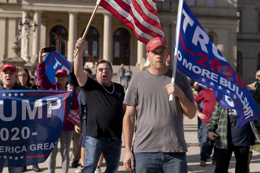 Trump supporters demonstrating the election results face off with counter protesters at the State Capitol in Lansing, Mich., Saturday, Nov. 7, 2020. Democrat Joe Biden defeated President Donald Trump to become the 46th president of the United States on Saturday, positioning himself to lead a nation gripped by the historic pandemic and a confluence of economic and social turmoil.