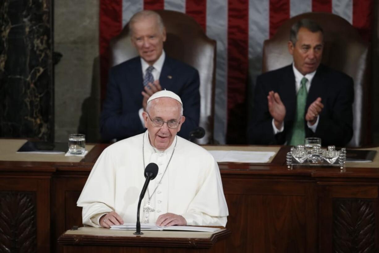 FILE - In this Thursday, Sept. 24, 2015 file photo, Pope Francis addresses a joint meeting of Congress on Capitol Hill in Washington, making history as the first pontiff to do so. Listening behind the pope are Vice President Joe Biden and House Speaker John Boehner of Ohio. President-elect Joe Biden, a lifelong Roman Catholic, spoke to Pope Francis on Thursday, Nov. 12, 2020, despite President Donald Trump refusing to concede. Trump claims -- without evidence -- that the election was stolen from him through massive but unspecified acts of fraud.